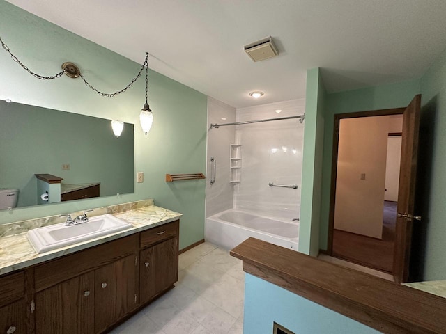 full bathroom with vanity, toilet, and  shower combination