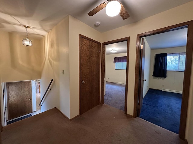 hall featuring dark carpet and baseboard heating