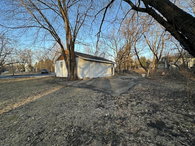 view of side of home featuring an outbuilding and a garage