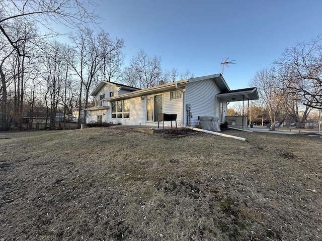 back of house with a lawn