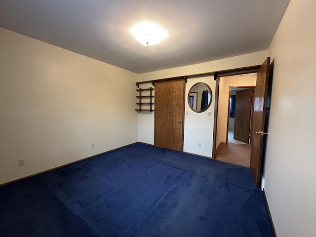 spare room with dark carpet