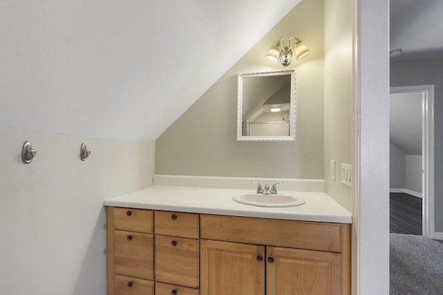 bathroom featuring vanity and lofted ceiling