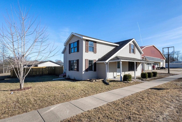 view of property featuring a porch and a front yard