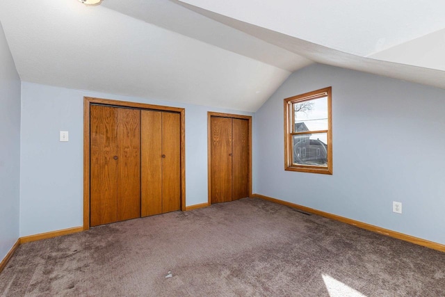 bonus room with light carpet and vaulted ceiling