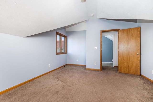 bonus room featuring vaulted ceiling and carpet floors