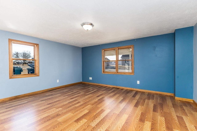 unfurnished room with wood-type flooring