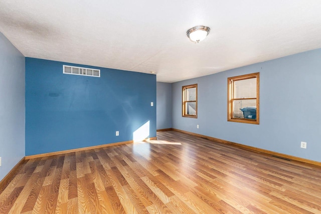 unfurnished room featuring hardwood / wood-style floors