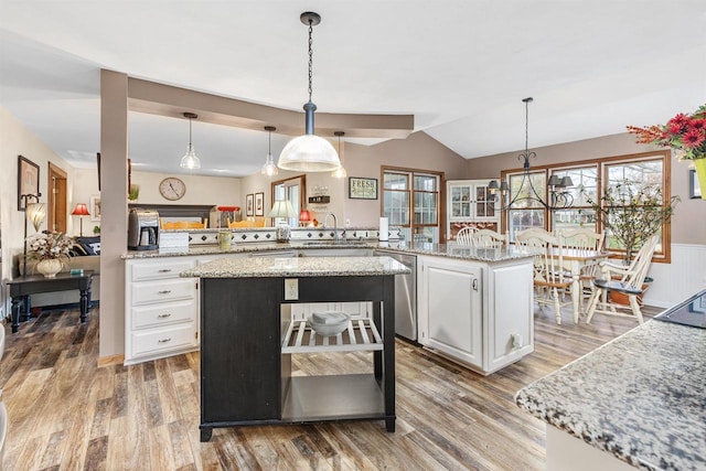 kitchen with white cabinetry, dishwasher, an island with sink, and kitchen peninsula