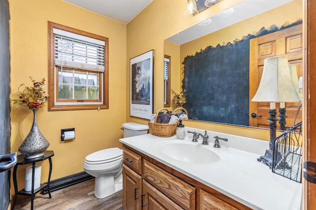 bathroom with hardwood / wood-style flooring, vanity, and toilet