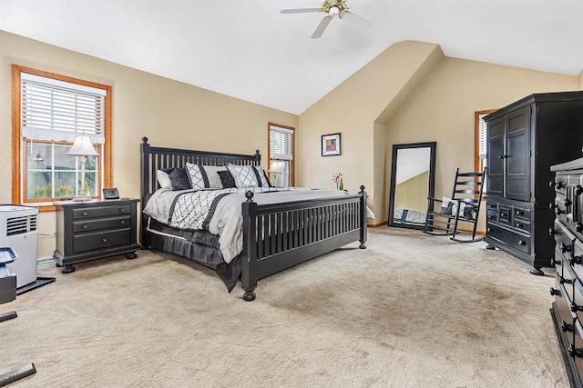 bedroom featuring vaulted ceiling, light colored carpet, and ceiling fan