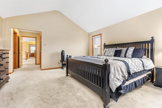 bedroom featuring lofted ceiling and light carpet