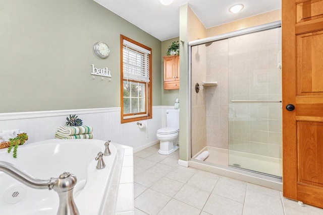 bathroom with toilet, tile patterned flooring, and shower with separate bathtub