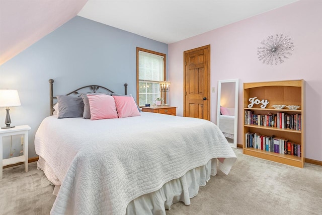 carpeted bedroom with lofted ceiling