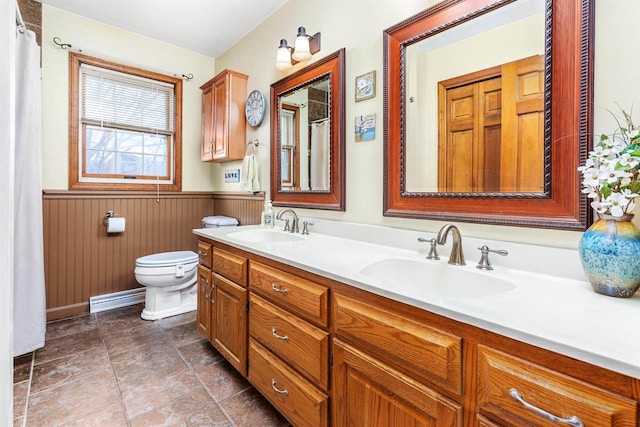 bathroom featuring vanity, toilet, and baseboard heating