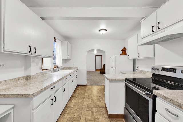 kitchen with white refrigerator, sink, stainless steel electric range, and white cabinets