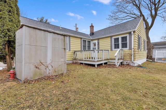 back of house featuring a yard and a deck