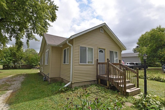 bungalow-style home with a front yard