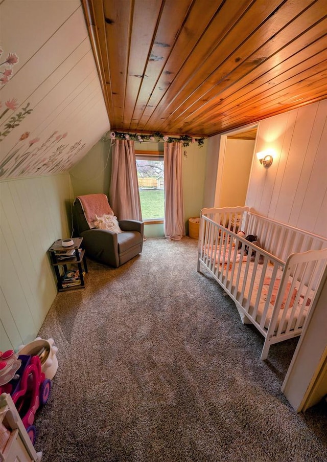 carpeted bedroom featuring a nursery area, wood walls, lofted ceiling, and wooden ceiling