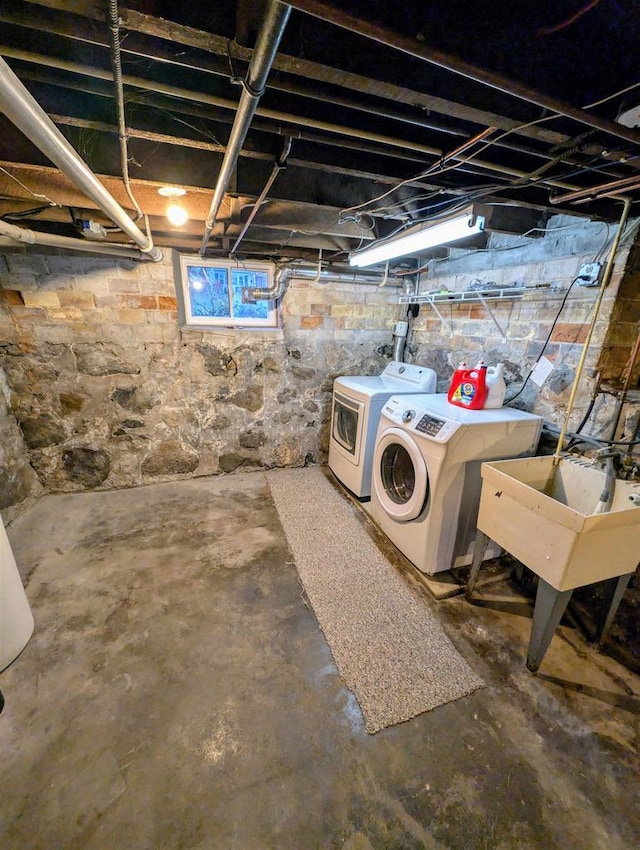 basement featuring sink and washer and clothes dryer