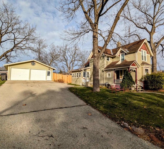 view of property exterior with a garage, a lawn, and covered porch