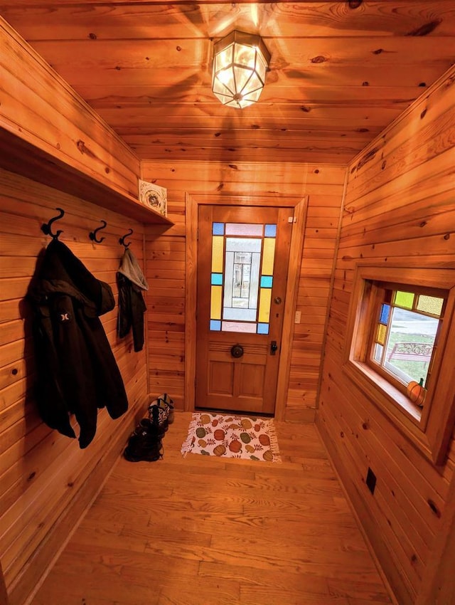 mudroom with wooden walls, light hardwood / wood-style flooring, and wooden ceiling