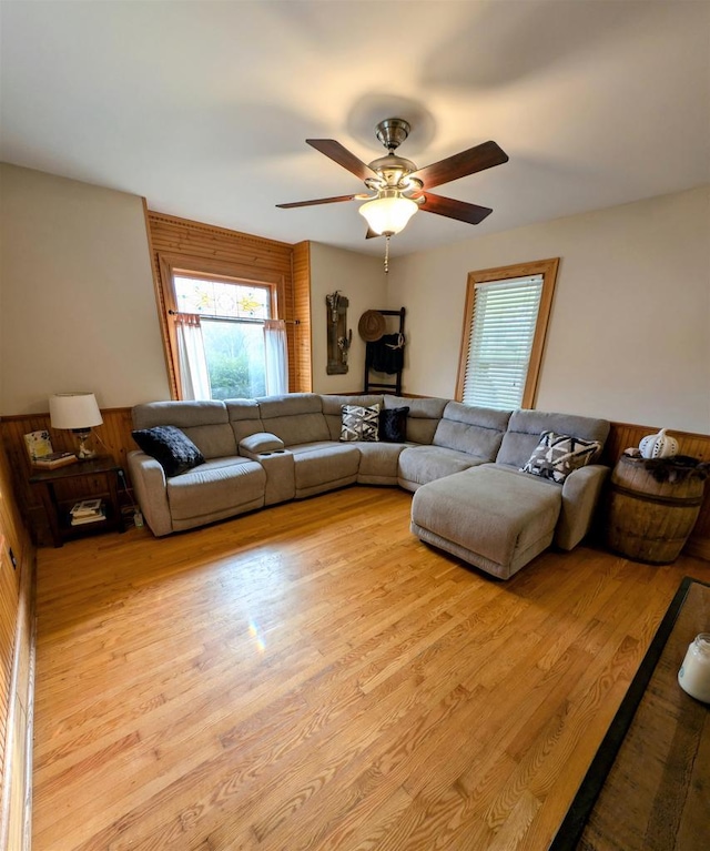 living room featuring ceiling fan and light hardwood / wood-style floors