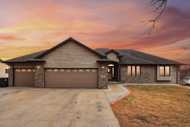 view of front of home featuring a garage and a lawn