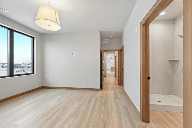 spare room featuring light hardwood / wood-style flooring