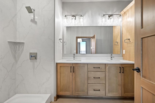 bathroom with vanity, wood-type flooring, and a tile shower