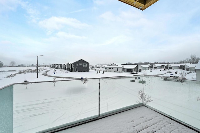 view of snow covered back of property