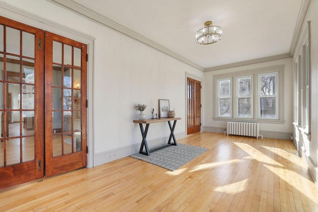 interior space featuring radiator heating unit, a notable chandelier, and french doors