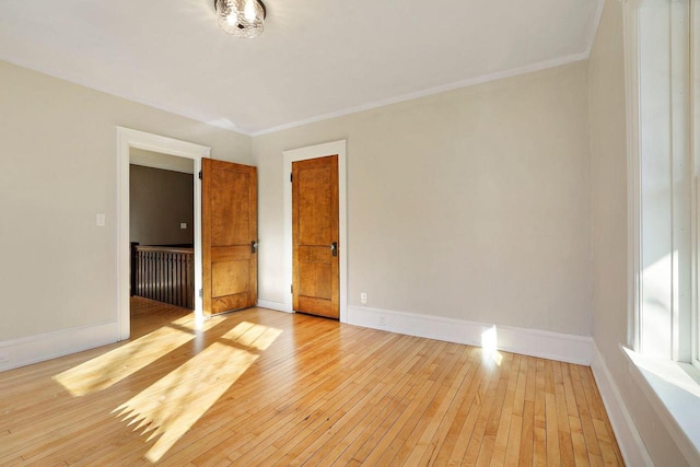 unfurnished bedroom with crown molding and light hardwood / wood-style floors