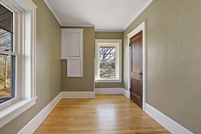 interior space with ornamental molding and light hardwood / wood-style floors