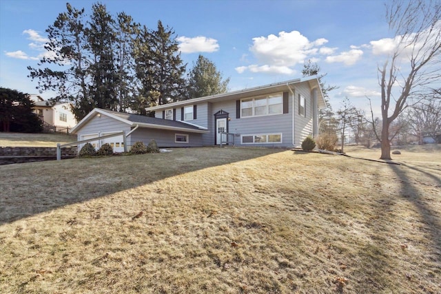 split foyer home featuring a garage and a front lawn