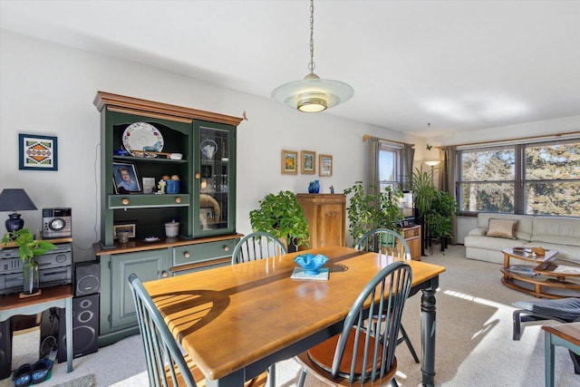 dining space featuring light colored carpet