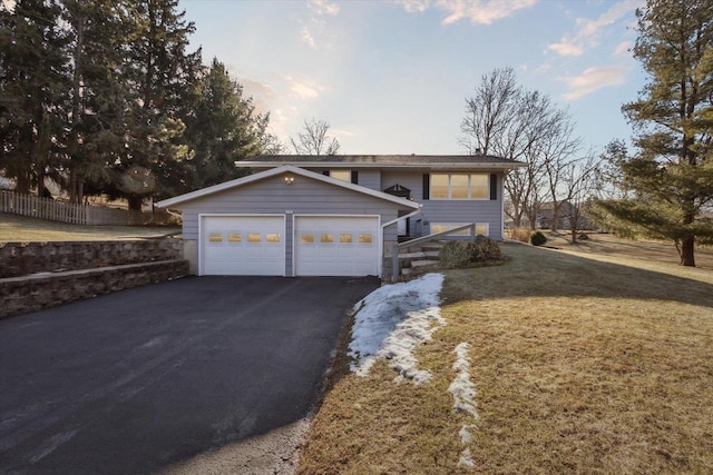 view of front of house with a garage and a lawn