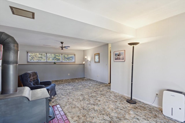 sitting room with carpet and ceiling fan