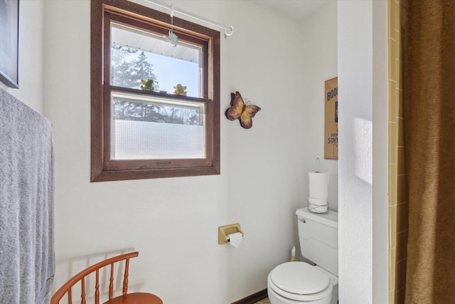 bathroom featuring a shower and toilet