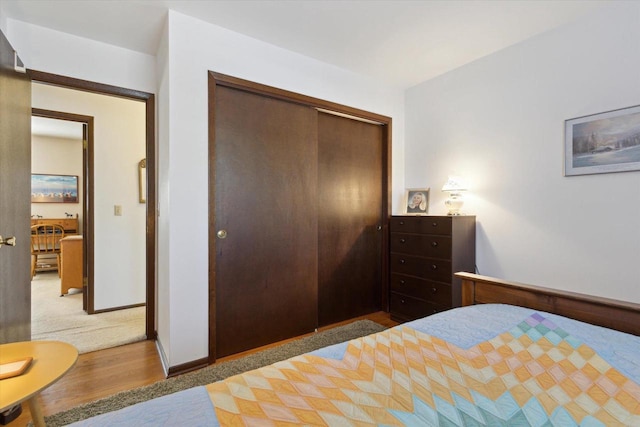 bedroom with hardwood / wood-style flooring and a closet