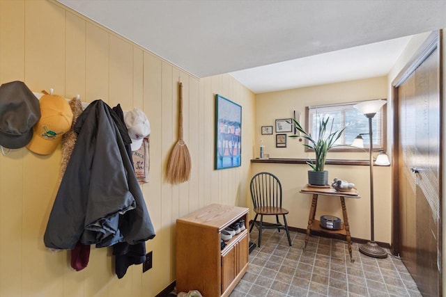 mudroom with wood walls