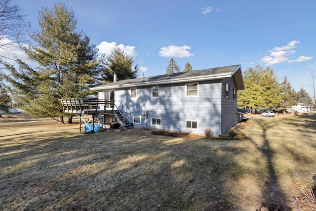 back of house featuring a deck, a lawn, and central air condition unit