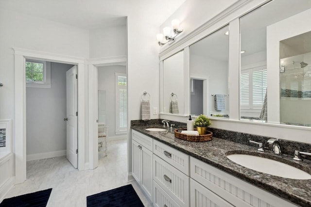 bathroom featuring vanity and a shower with door