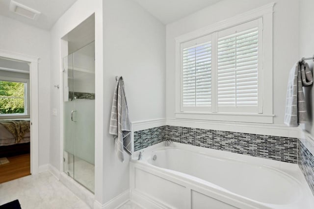 bathroom featuring separate shower and tub