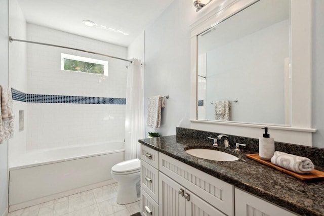 full bathroom with tiled shower / bath combo, vanity, and toilet