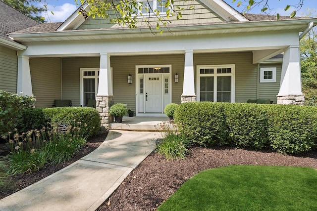 view of exterior entry featuring covered porch