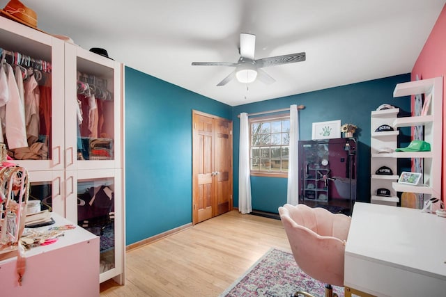 office with ceiling fan and light hardwood / wood-style flooring