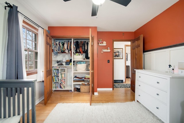 bedroom featuring light hardwood / wood-style floors, a closet, and ceiling fan