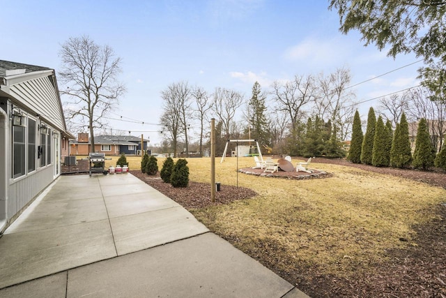 view of yard with a playground and a patio