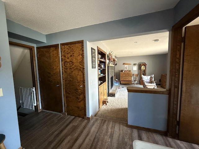 hallway with hardwood / wood-style flooring and a textured ceiling