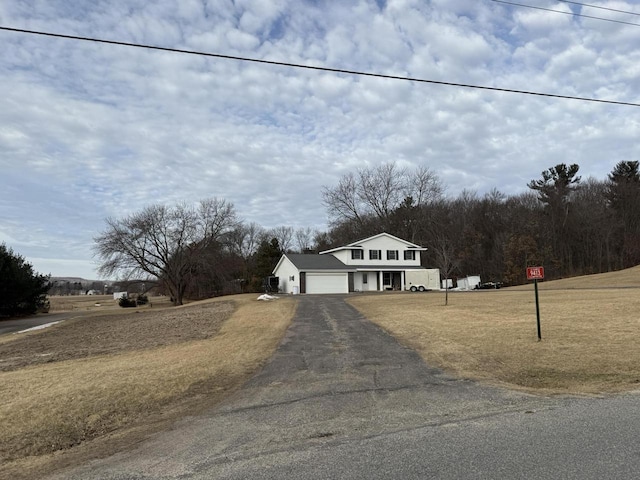 view of front of home with a garage and a front lawn